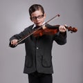 Smile, music and kid with violin in studio for practice with suit and glasses for fashion. Happy, style and cute young