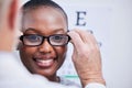 Smile, optometry and a black woman with glasses and a doctor for consultation and eye care. Happy, clinic and an African