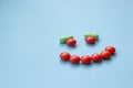 Smile from orange and green pills, the concept of successful recovery Royalty Free Stock Photo