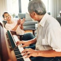 Smile, piano and senior man playing a song to his wife for music in living room with bonding or entertainment. Happy Royalty Free Stock Photo