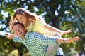 Smile, piggy back and couple in park for summer romance, trees and playful outdoor date. Love, mature man and happy Royalty Free Stock Photo