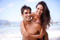 Smile, piggyback and portrait of couple by beach on vacation, adventure or holiday for romantic travel. Happy, love and Royalty Free Stock Photo