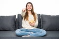 Smile and pointed Young woman watching TV and eating chips on sofa Royalty Free Stock Photo
