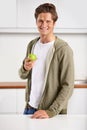 Smile, portrait and man with apple in kitchen of home for diet, health and wellness. Happy, confident and young male Royalty Free Stock Photo