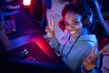 Smile Portrait Streamer African young woman professional gamer playing online games computer, neon color