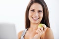Smile, portrait and woman nutritionist with apple in studio for wellness, diet or eating plan on white background