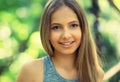 Smile. Portrait of a young beautiful smiling American woman, sunshine girl isolated green outdoors park background Royalty Free Stock Photo