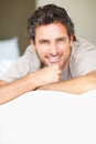 Smile, relax and portrait of mature man in bed in morning after nap, break or comfortable sleep at home. Happy, idea and Royalty Free Stock Photo