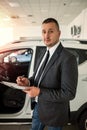 smile salesman or client alone at new car showroom Royalty Free Stock Photo