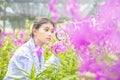 Smile Scientists hold magnifiers, happy with success. Researcher botanical research orchid wearing Scientist shirt Royalty Free Stock Photo