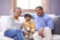 Smile, sofa and portrait of grandparents with kid for bonding, support and care in living room. Relax, senior people and Royalty Free Stock Photo