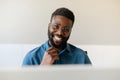 The smile of success. Portrait of happy african american businessman working in his office, sitting in front of computer Royalty Free Stock Photo