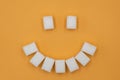 Smile symbol, composed of cubes of sugar. Concept of sugar leading to caries