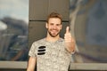 Smile and thumbs up. Handsome guy smiling and gesturing thumbs up. Happy man in casual style extending hand with thumbs Royalty Free Stock Photo