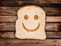 A smile toasted on a slice of bread, on wood