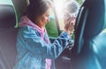 Smile tourist girl in an open window of a auto car taking photography click on digital photo camera, photographer looking on camer Royalty Free Stock Photo