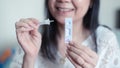 Smile woman is holding covid-19 antigen selftest for nasal swab with showing negative result. Medical device for corona virus test Royalty Free Stock Photo