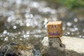 Smile on wooden block in the river