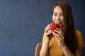 Smile young Asian woman holding a red cup and enjoying drinking warm coffee in the morning, Concept of relaxation in leisure and