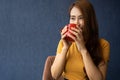 Smile young Asian woman holding a red cup and enjoying drinking warm coffee in the morning, Concept of relaxation in leisure and