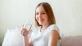 Smile young woman drinks glass of pure water in morning after waking up in her bed room. Happy teen girl maintains water balance Royalty Free Stock Photo