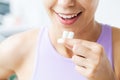 Smile young woman eating white chewing gum