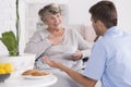 Smiled elder woman and her young male nurse Royalty Free Stock Photo