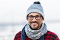 Smiled man in glasses. Portrait of smiling urban man in glasses and hat. Happy smiled guy in winter knitted hat and scarf. Royalty Free Stock Photo