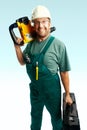 Smiled workman hold perforator and black suitcase Royalty Free Stock Photo