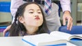 Smiley asian cute girl sitting and reading book on the table