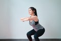 Smiley Asian woman wearing sportswear and practice yoga in living room. Healthy lifestyle concept.