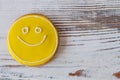 Smiley biscuit on wooden surface. Royalty Free Stock Photo