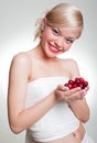 Smiley blonde with cherries in her palms Royalty Free Stock Photo