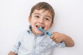 Smiley boy cleans a teeth isolated on grey background