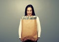 Smiley businesswoman holding paper bag Royalty Free Stock Photo