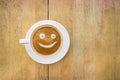 Smiley coffee latte on wood table