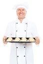 Smiley cook holding baking tray with cookies Royalty Free Stock Photo