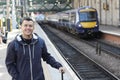 Smiley ethnic male waiting for a train