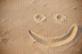 A smiley face drawing on a sand Royalty Free Stock Photo