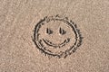 Smiley face drawn on beach sand Royalty Free Stock Photo