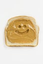 Smiley face drawn in peanut butter on slice of toa Royalty Free Stock Photo