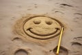 smiley face drawn in sand with a stick Royalty Free Stock Photo