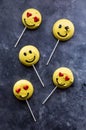 Smiley face emoticon merengue cookies with lollipop sticks. Royalty Free Stock Photo