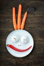 Smiley face made from pepper, garlic,flavoring and carrots Royalty Free Stock Photo