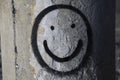 Smiley face spray painted on weathered concrete wall. Royalty Free Stock Photo
