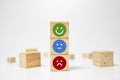 smiley face on wood block cube - business services rating customer experience, Satisfaction survey concept - Feedback Royalty Free Stock Photo