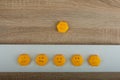 smiley-faced group of sad emojis against the background of a wooden table. Be positive. Royalty Free Stock Photo