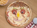 Smiley Faced Pizza with a Portion of Chips Royalty Free Stock Photo