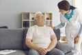Friendly doctor or helpful nurse comes to see senior patient at home or in assisted living facility