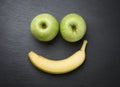 Smiley with fresh fruits on slate stone.